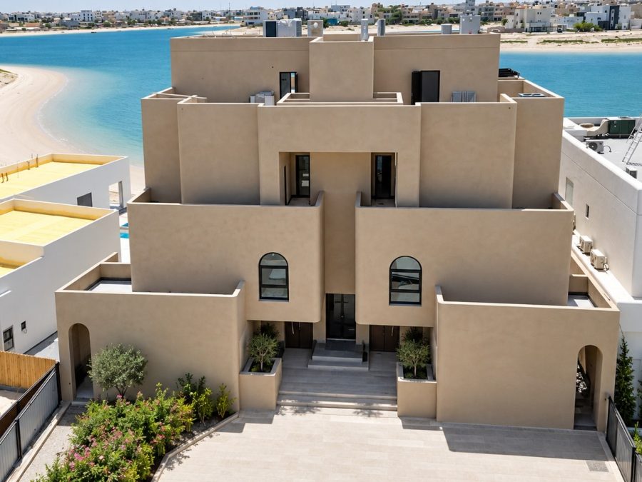 Beige rendered villa facing the water after completion